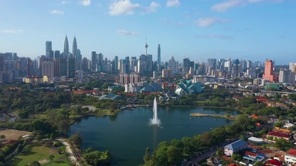 February 23rd, 2020 - Kuala Lumpur, Malaysia : 4k Establishing b-roll aerial shot of drone moving forward towards Kuala Lumpur city skyline. Flying over Titiwangsa Lake. Green and Sustainable City