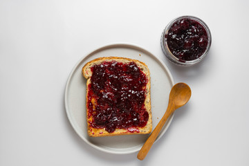 Toasted bread with berry jam, top view. Traditional breakfast.