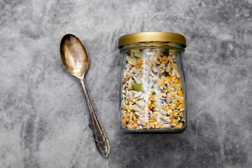 Healthy seeds mix in a glass jar, top view. Healthy foods, vegan food ingredient.