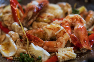Selective focus of fried stir spicy sea food in pan, Pad Cha Talay Sea Food, Thai food. Close up