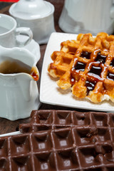 Tasty Belgian dessert, Brussels waffles with chocolade, syrup and white sugar powder