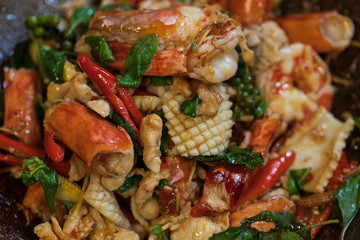 Selective focus of fried stir spicy sea food in pan, Pad Cha Talay Sea Food, Thai food. Close up