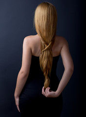 Beautiful female back. Portrait of a long haired woman. Back.
