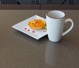 Cup of tea and dessert on the table.