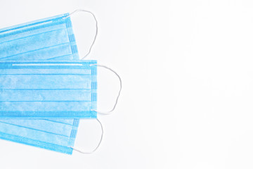 Three blue medical masks on a light background. flat lay. medical background. copy space