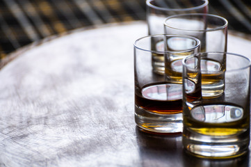 Special tumbler glasses for Scotch whisky, tasting tour on distillery in Scotland, UK and dark tartan
