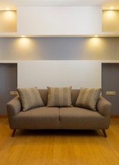 Plush comfortable sofa with decorations in the background 