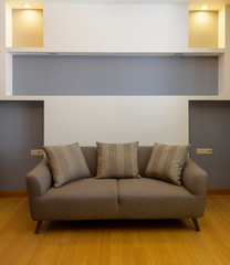 Plush comfortable sofa with decorations in the background 