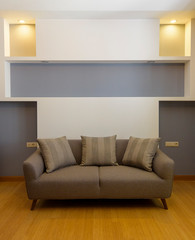 Plush comfortable sofa with decorations in the background 