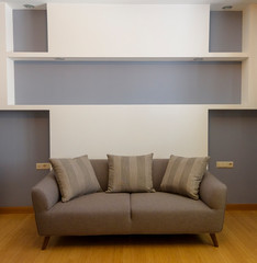 Plush seating arrangement with blank wall shot as a background for artists to insert their art frames to use in advertising. 