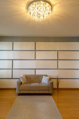 Plush seating arrangement with blank wall shot as a background for artists to insert their art...