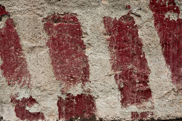 red stripes painted on the concrete as a warning and an indication of the size and limits as background or texture