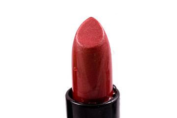 red lipstick in a black body on a white isolated background