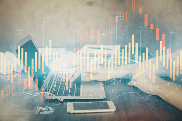 Double exposure of forex chart with man working on computer on background. Concept of market analysis.