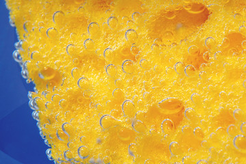 dishwashing sponge texture background. Surface of yellow sponge for washing dishes. close-up underwater