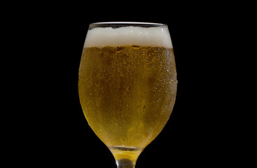 Misted glass of beer with froth