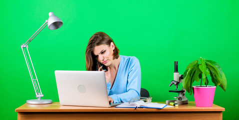 Texting to colleague. information. Business communication. woman with microscope on table. businesswoman talking on phone. woman work in office at laptop. secretary use mobile phone at workplace