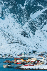 Buildings in front of snow covered mountains, Norway.