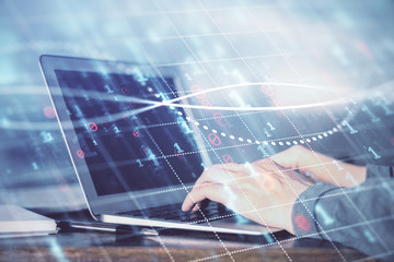 Double exposure of stock market graph with man working on laptop on background. Concept of financial analysis.