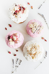 Glazed easter cake decorated with flowers on white textured background. Happy Easter Holidays