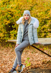 Time to rest. cosy sport suit. sporty girl with puffed jacket. wear comfort clothes. warm clothes for fall season. woman in hat enjoy autumn season. walking in park. girl relax among fallen leaves