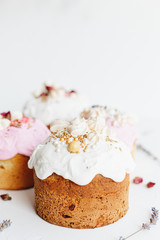 Glazed easter cake decorated with flowers on white textured background. Happy Easter Holidays