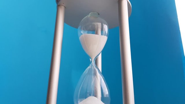 Elegant hourglass on a blue background. Concept-business time money, education, time is running out, time management, time resource, fulltime, deadline