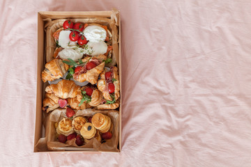 Food delivery box for breakfast. Food delivery from markets and restaurants. Meal for a week on quarantine. Fresh sandwiches, pancakes and eggs at the craft box.