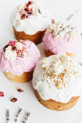 Glazed easter cake decorated with flowers on white textured background. Happy Easter Holidays