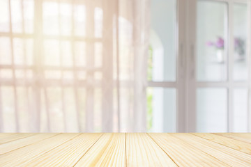 Empty wood table top with window curtain abstract blur background for product display