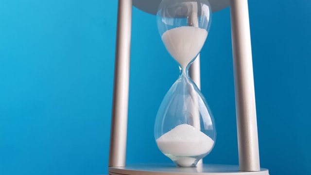 Elegant hourglass on a blue background. Concept-business time money, education, time is running out, time management, time resource, fulltime, deadline