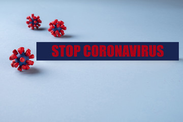 Inscription Stop Coronavirus on blue background and models of covid-19 virus.Virus pandemic...