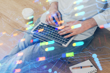 Multi exposure of data internet theme hologram with man working on computer on background. Concept...