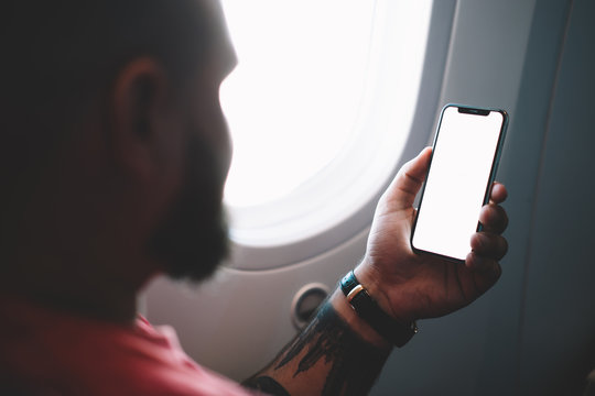 Crop Passenger Watching Smartphone Traveling On Plane