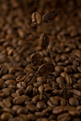 falling grains of coffee on a black background
