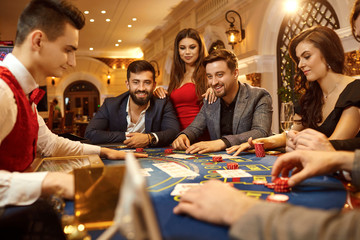 A group of people playing poker roulette in a casino
