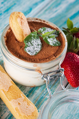 tiramisu in a glass Cup on a wooden table