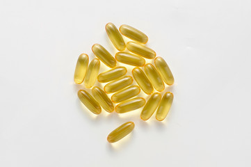 Heap pills of black cumin seeds essential oil Nigella Sativa on white background