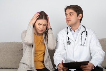 Doctor consulting female patient at home
