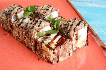 Dessert Maki sushi roll with various fruits and cream cheese inside.