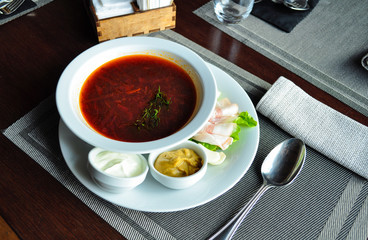 Borsch with veal and homemade bacon with sour cream and mustard and herbs