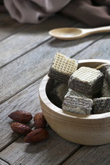 Milk chocolate flavored wafers on old wooden floors