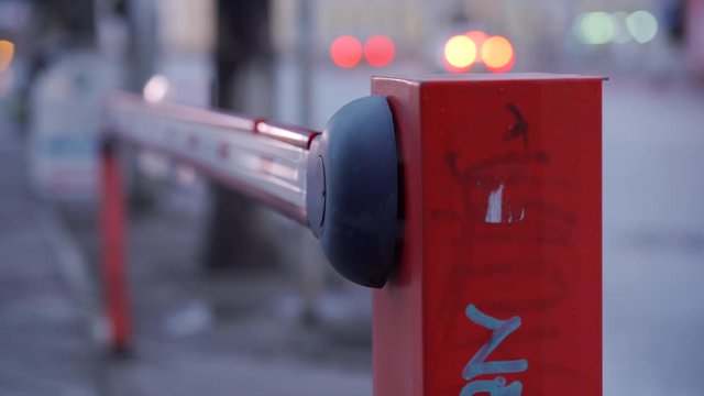 Parking lot automatic road boom barrier system gate on a city street.