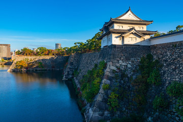 Japan. A samurai castle on a high stone wall. Attractions Of Osaka. The castle is divided by a moat. Japanese castles. A hard-to-reach Japanese building. Guide to Osaka.