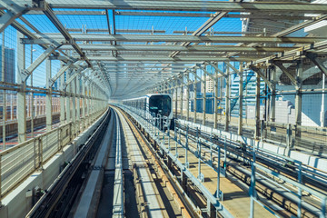 Japanese railway transport. The train goes on the tracks in Tokyo. Transport infrastructure of Japan. Transportation of passengers around the city. Tokyo trains.