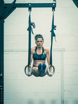 Exercising  Woman Holding Gymnast Rings