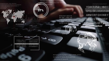 Man working on laptop computer keyboard with graphic user interface GUI hologram showing concepts...