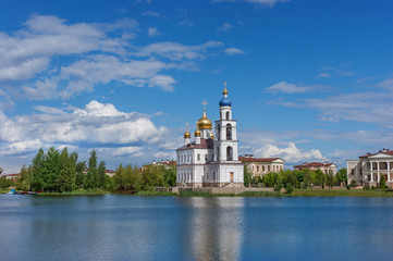 Fototapeta na wymiar East Christian Orthodox Church by the Lake. Bright, summer day.