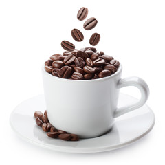 White cup with roasted coffee beans, isolated on white background
