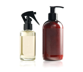 plastic spray bottle and lotion bottle isolated on white